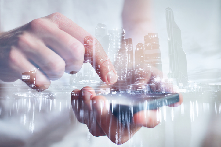 man hands touching smartphone, closeup, double exposure with modern city skyline